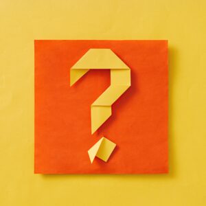Layered orange and yellow background with origami question mark